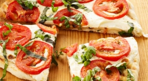 Pizza cu mozzarella, roșii cherry și busuioc